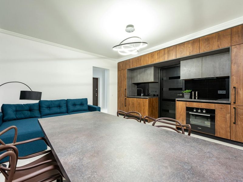 Spacious living room with wooden floor suitable for home practice.